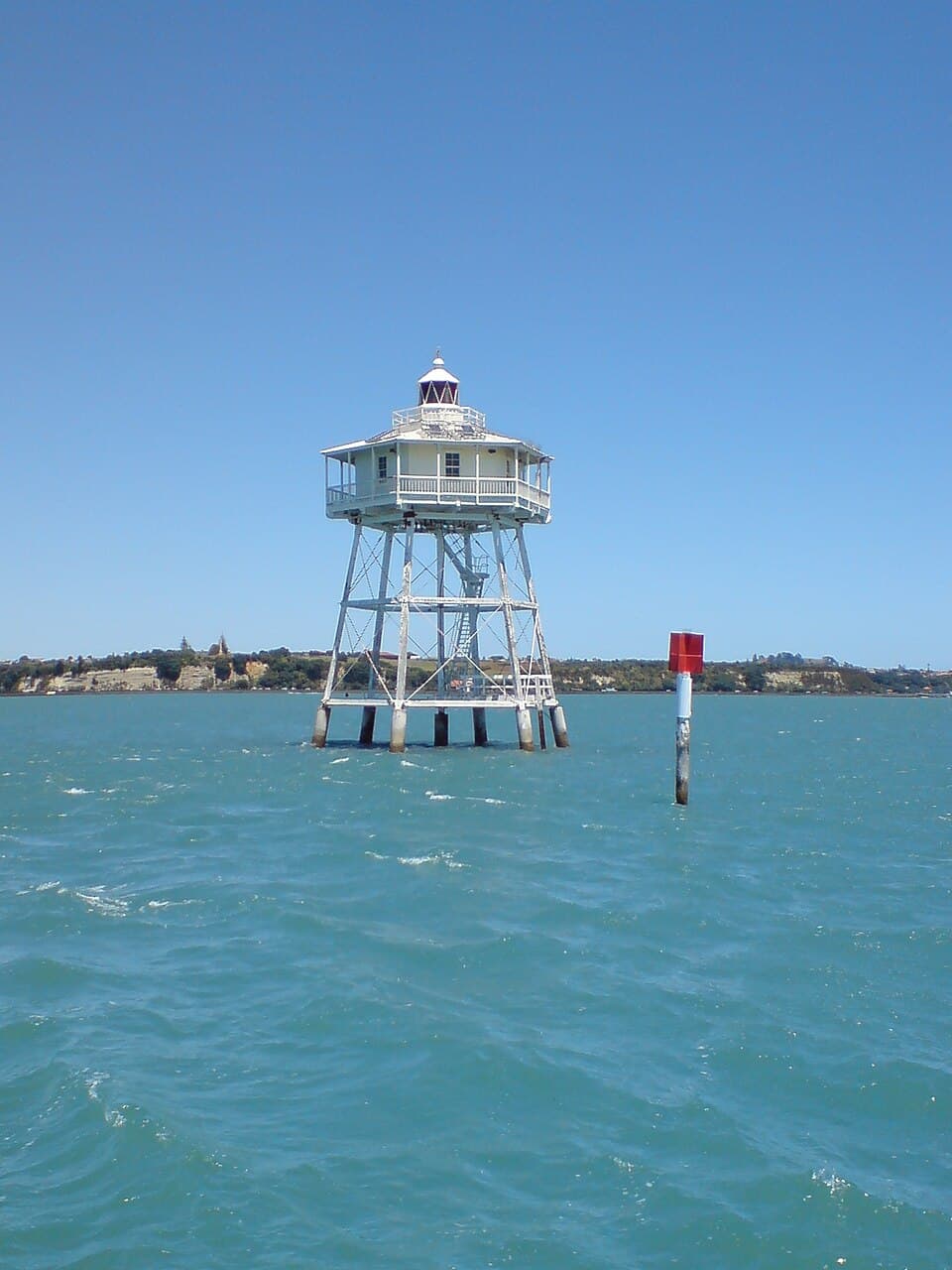 An old lighthouse (Bean Rock) near the entrance to the Waitemata Harbour in the Hauraki Gulf of New Zealand, somewhere south of Rangitoto Island. New Zealand…